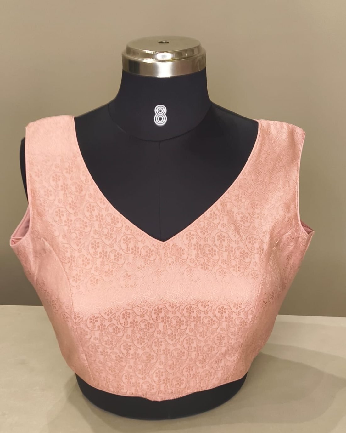 Blush Brocade V Neck Blouse photographed on a dress form at the Ananta Designs boutique