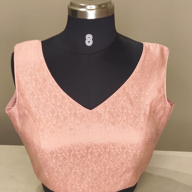 Blush Brocade V Neck Blouse photographed on a dress form at the Ananta Designs boutique