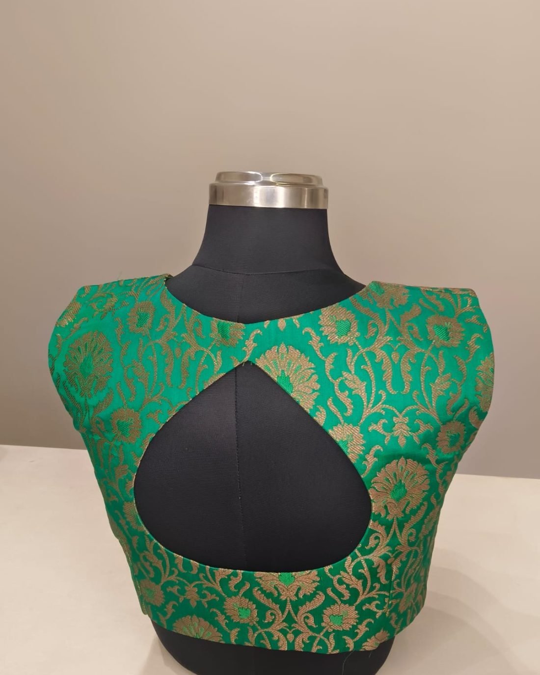 Green Gold Brocade Keyhole Blouse photographed on a dress form at the Ananta Designs boutique
