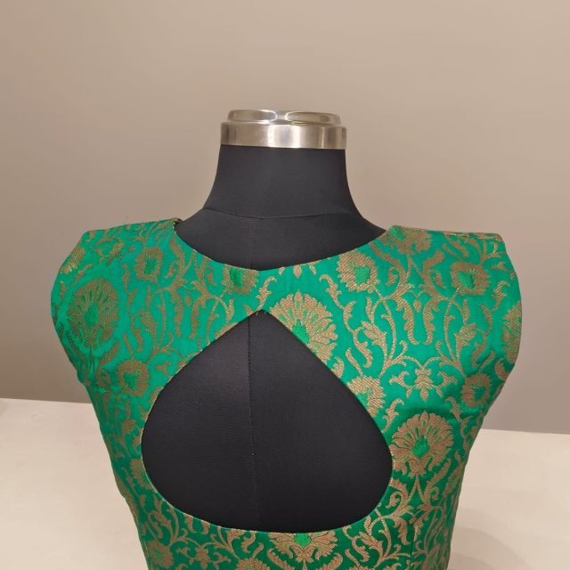 Green Gold Brocade Keyhole Blouse photographed on a dress form at the Ananta Designs boutique