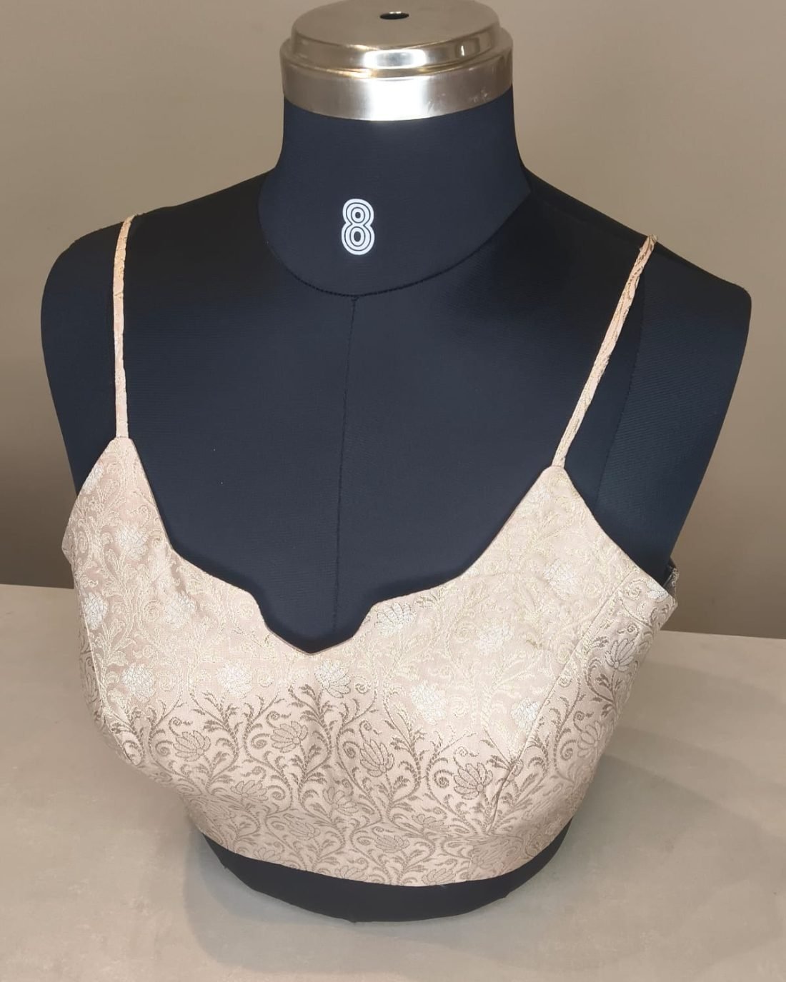 Ivory Brocade Strap Blouse photographed on a dress form at the Ananta Designs boutique