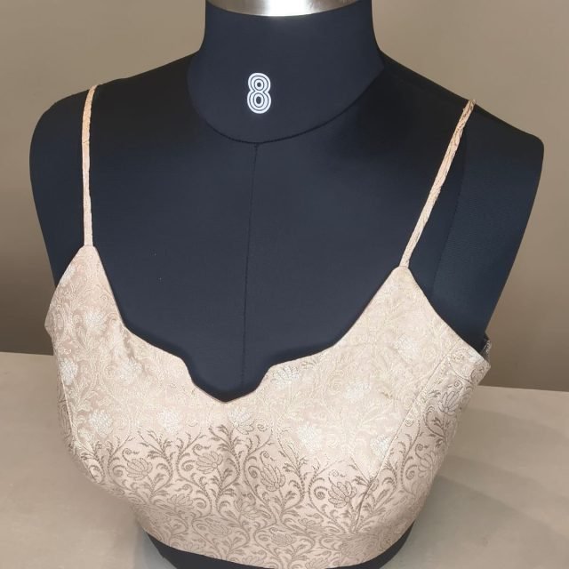 Ivory Brocade Strap Blouse photographed on a dress form at the Ananta Designs boutique