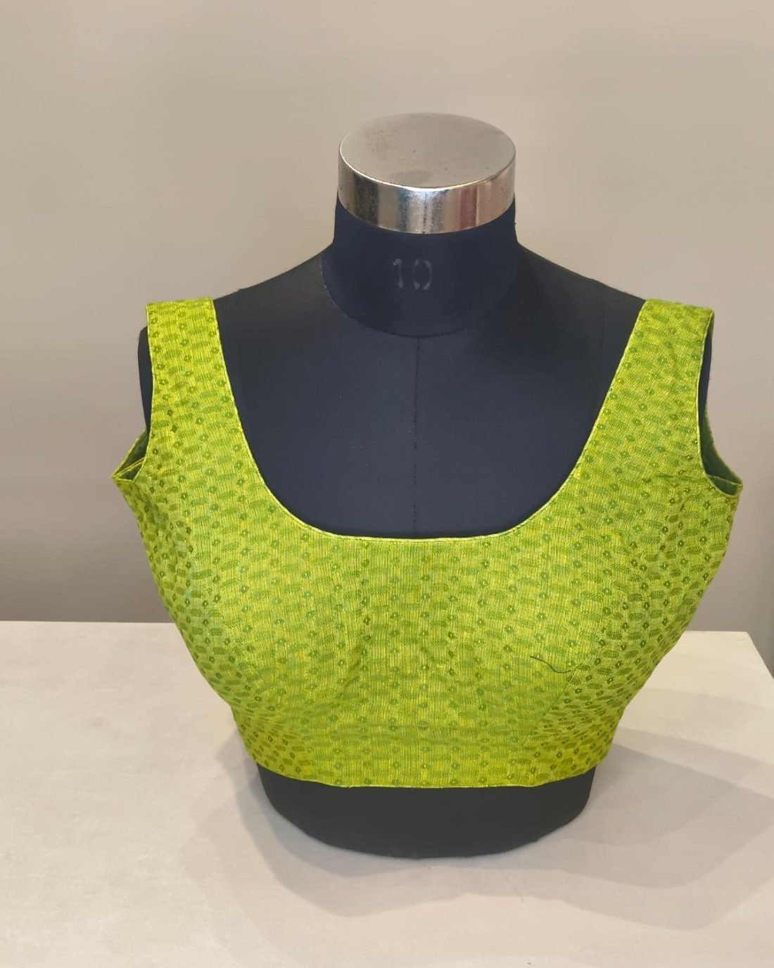 Lime Green Textured Blouse photographed on a dress form at the Ananta Designs boutique