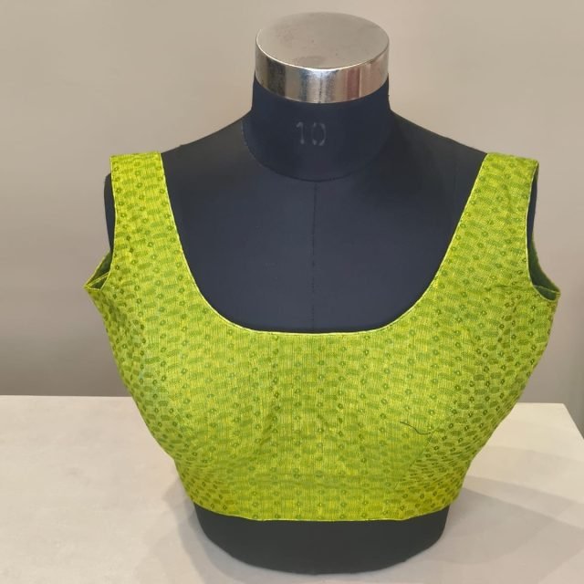 Lime Green Textured Blouse photographed on a dress form at the Ananta Designs boutique