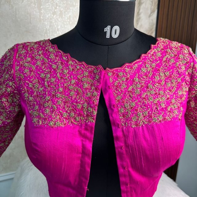 Magenta Gold Embroidered Blouse photographed on a dress form at the Ananta Designs boutique
