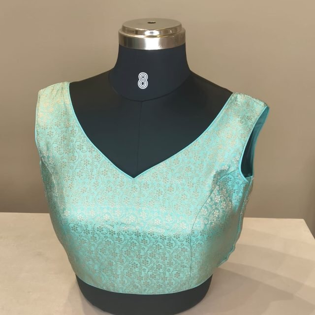 Mint Green Brocade V Neck Blouse photographed on a dress form at the Ananta Designs boutique