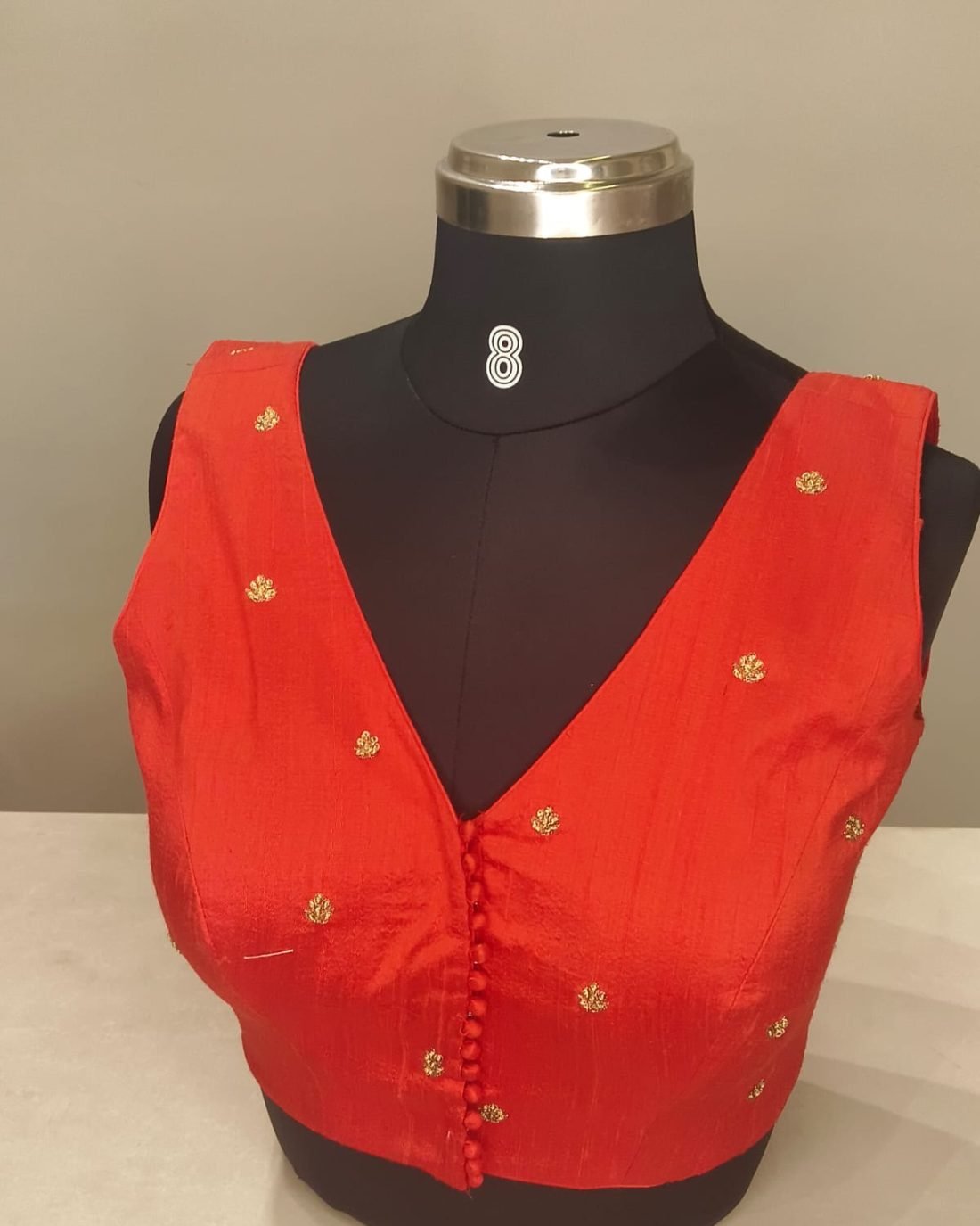 Red Silk Button Front Blouse photographed on a dress form at the Ananta Designs boutique