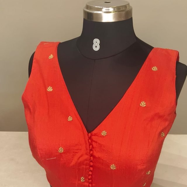 Red Silk Button Front Blouse photographed on a dress form at the Ananta Designs boutique