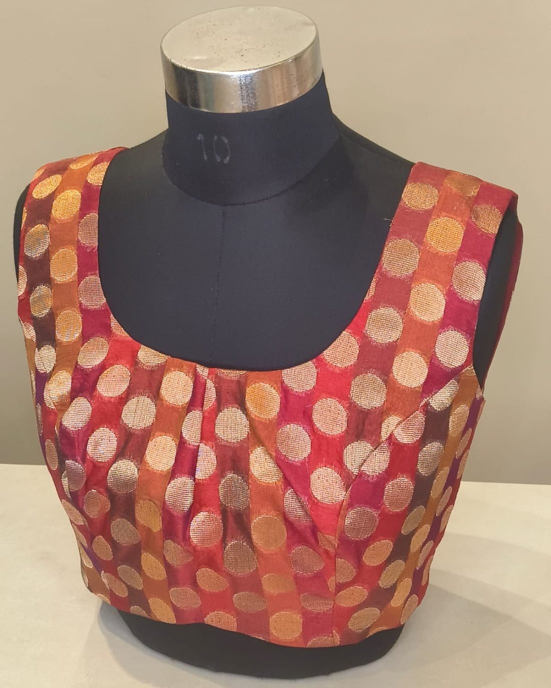 Rust Gold Brocade Polka Blouse photographed on a dress form at the Ananta Designs boutique