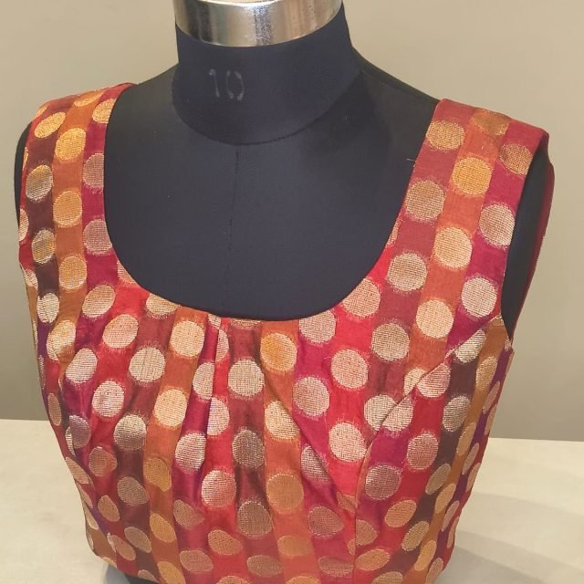 Rust Gold Brocade Polka Blouse photographed on a dress form at the Ananta Designs boutique